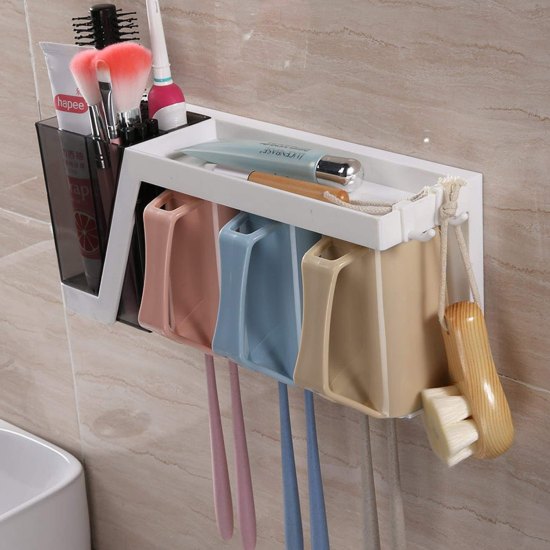 Bathroom wall organizer with toothbrushes, toothpaste, and other items on a tiled wall.